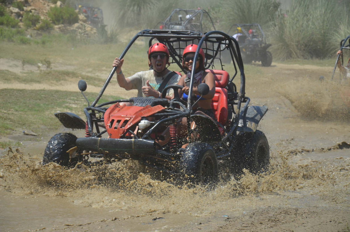 Disabled Baddie Betty driving an off road buggy through muddy water with one arm, & soaking Dad !
