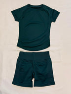 Pearl, Pine Green, Ladies Gym set. Short-sleeve top and matching high-waisted shorts with scrunch bum, laid flat.